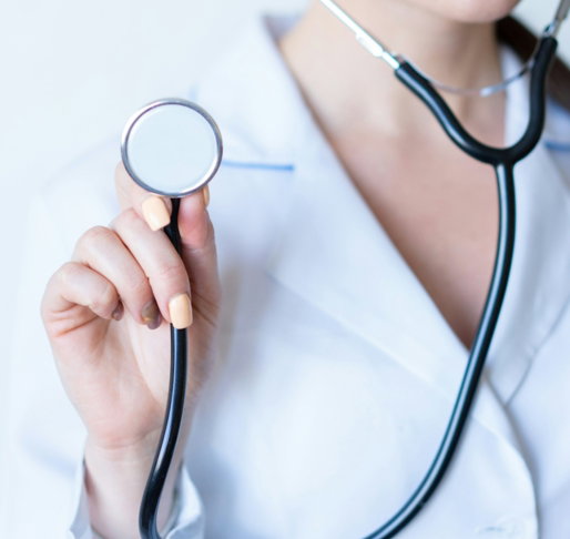 a woman in a white shirt holding a stethoscope